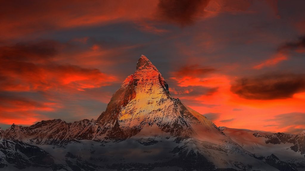 Alpská země může mluvit například o vrcholcích hor, jódlování a hodinkách
